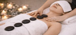 Heated basalt stones placed on the body during a hot stone therapy massage to relax muscles and improve circulation.