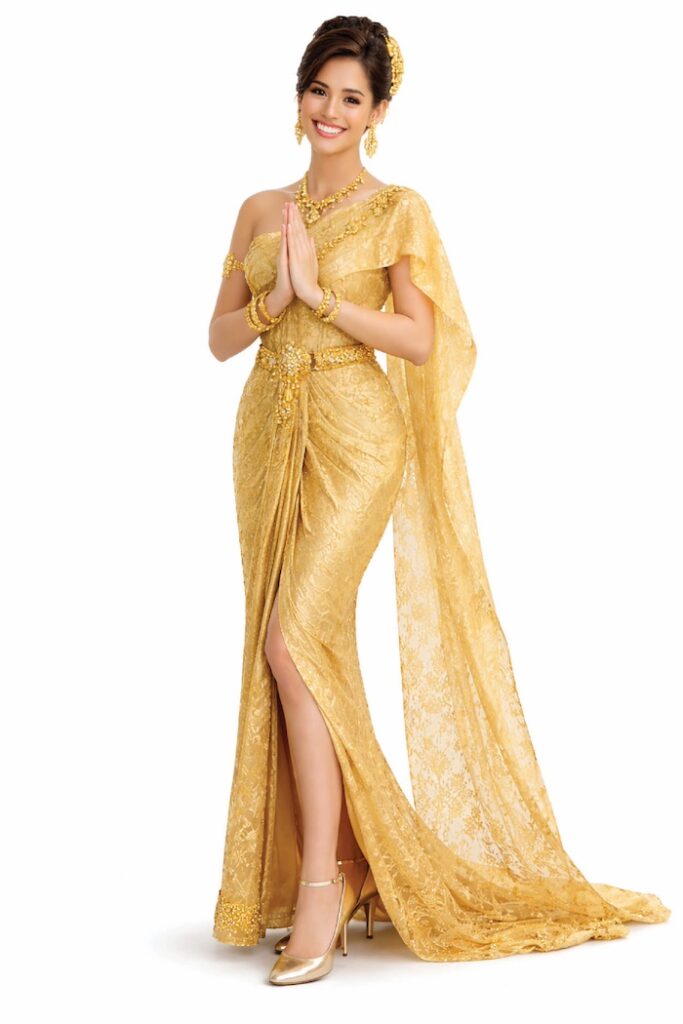 Woman in a modern Chi-Wa Siam inspired outfit posing elegantly with Thai-style design elements.