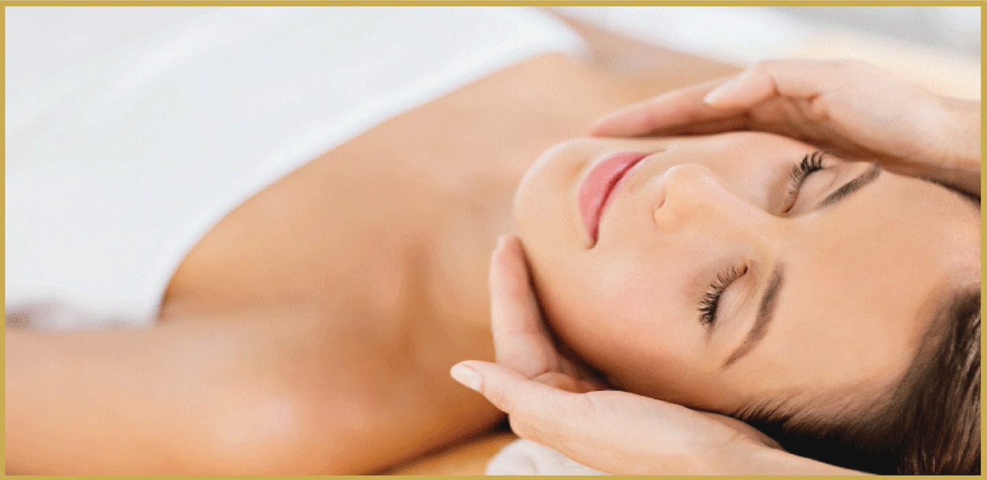 Woman using a facial sauna set at home, releasing warm steam for skincare.